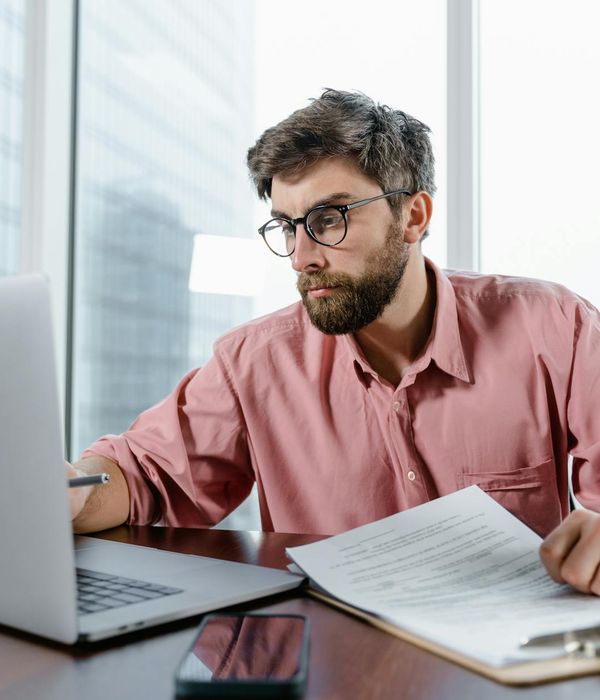 Tax specialist examining corporate documentation with digital tools